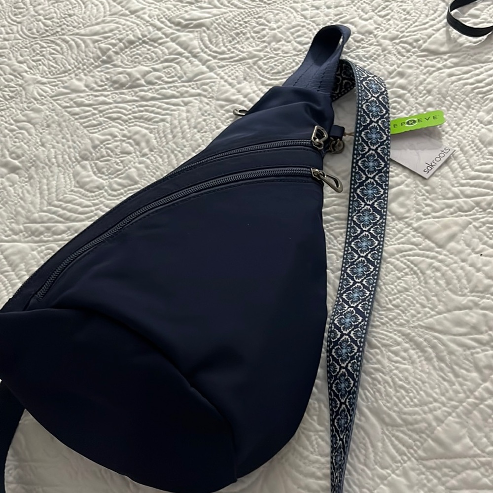 Sakroots backpack. Navy EcoTwill fabric. 9” L x 6” W x 15” H. 28.5” drop.